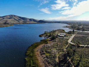 Aerial View Of Otay Lake Reservoir With Blue Sky And Mountain