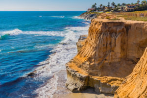 Eroded Cliff Of Carlsbad With Breaking Surf, Ca